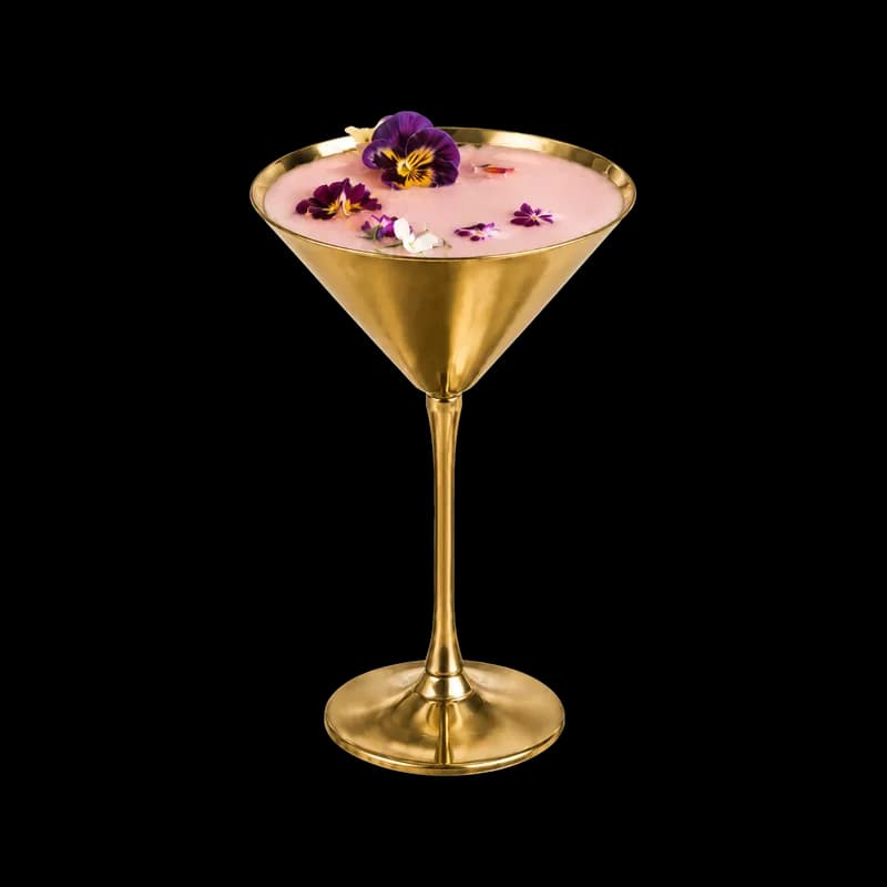 The Bloom Martini, a pink lychee martini in a gold glass topped with an edible flower, at Bloom cocktail bar, Park Street, Bristol
