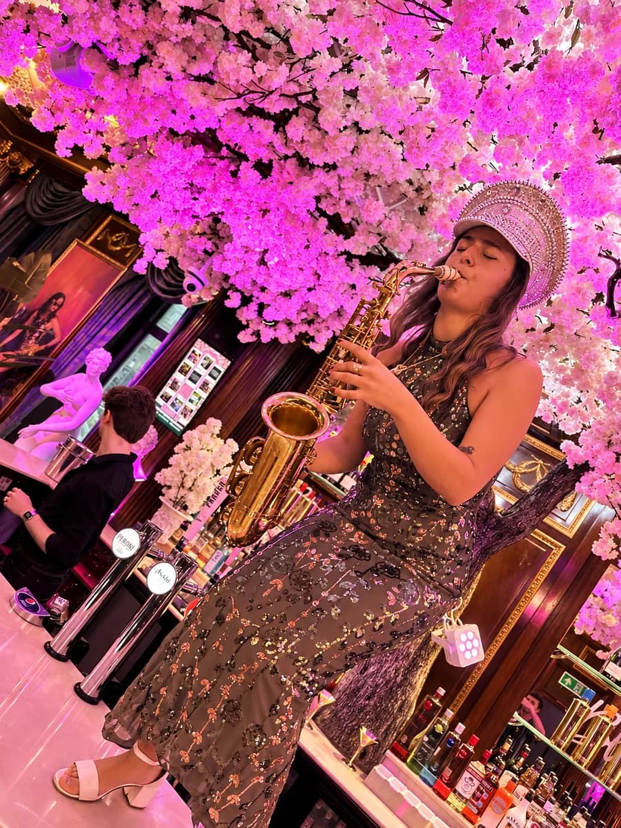 Live sax player performing under the cherry blossom at Bloom cocktail bar, Park Street, Bristol
