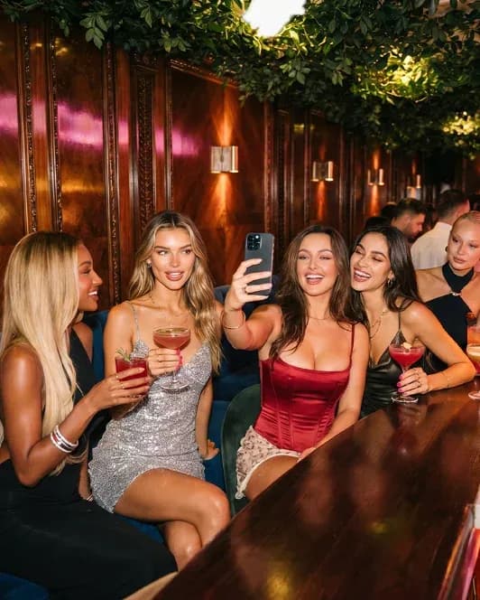 A group taking a selfie with cocktails at Bloom Bristol